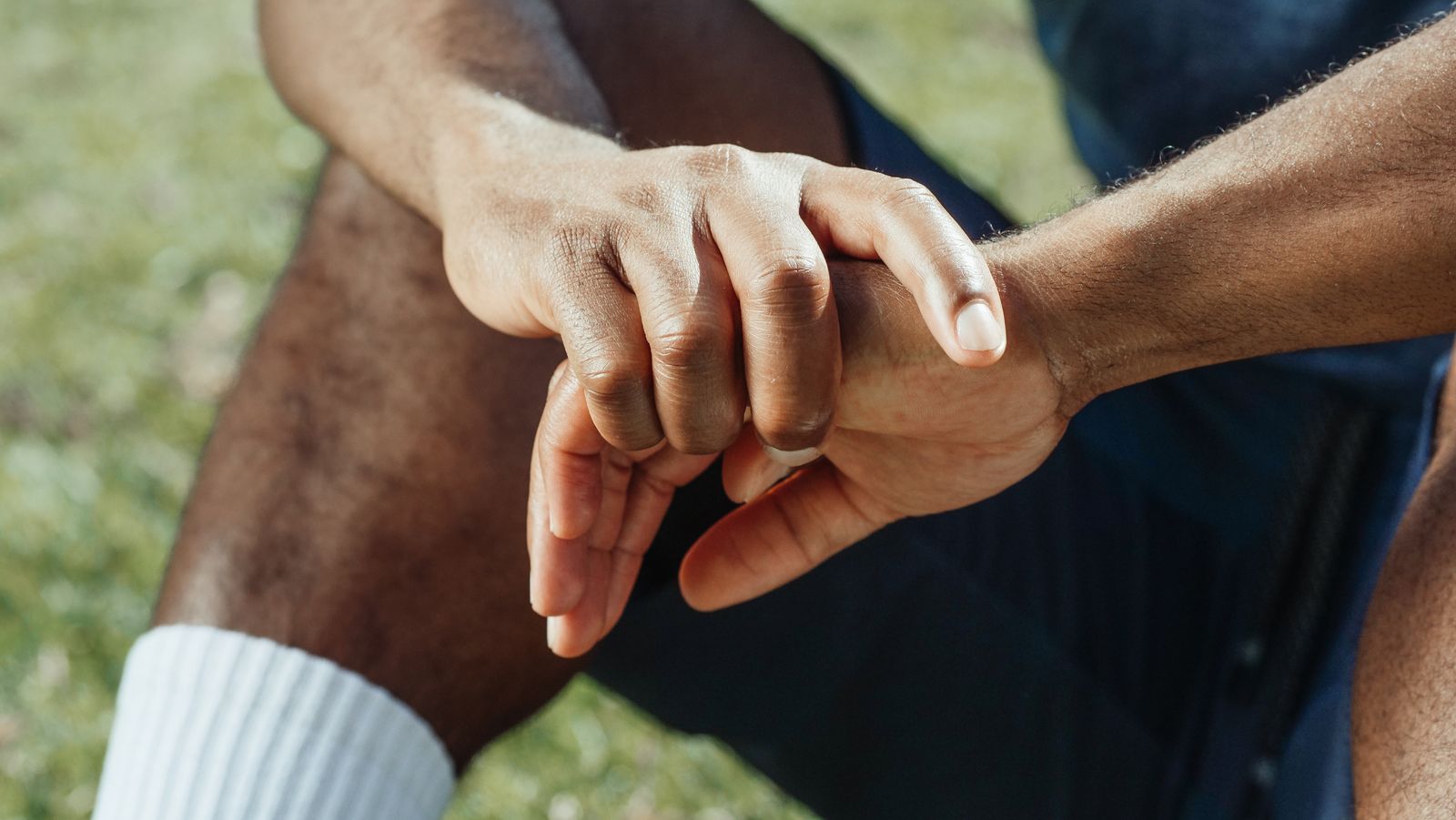 Person holding a painful hand and wrist joint