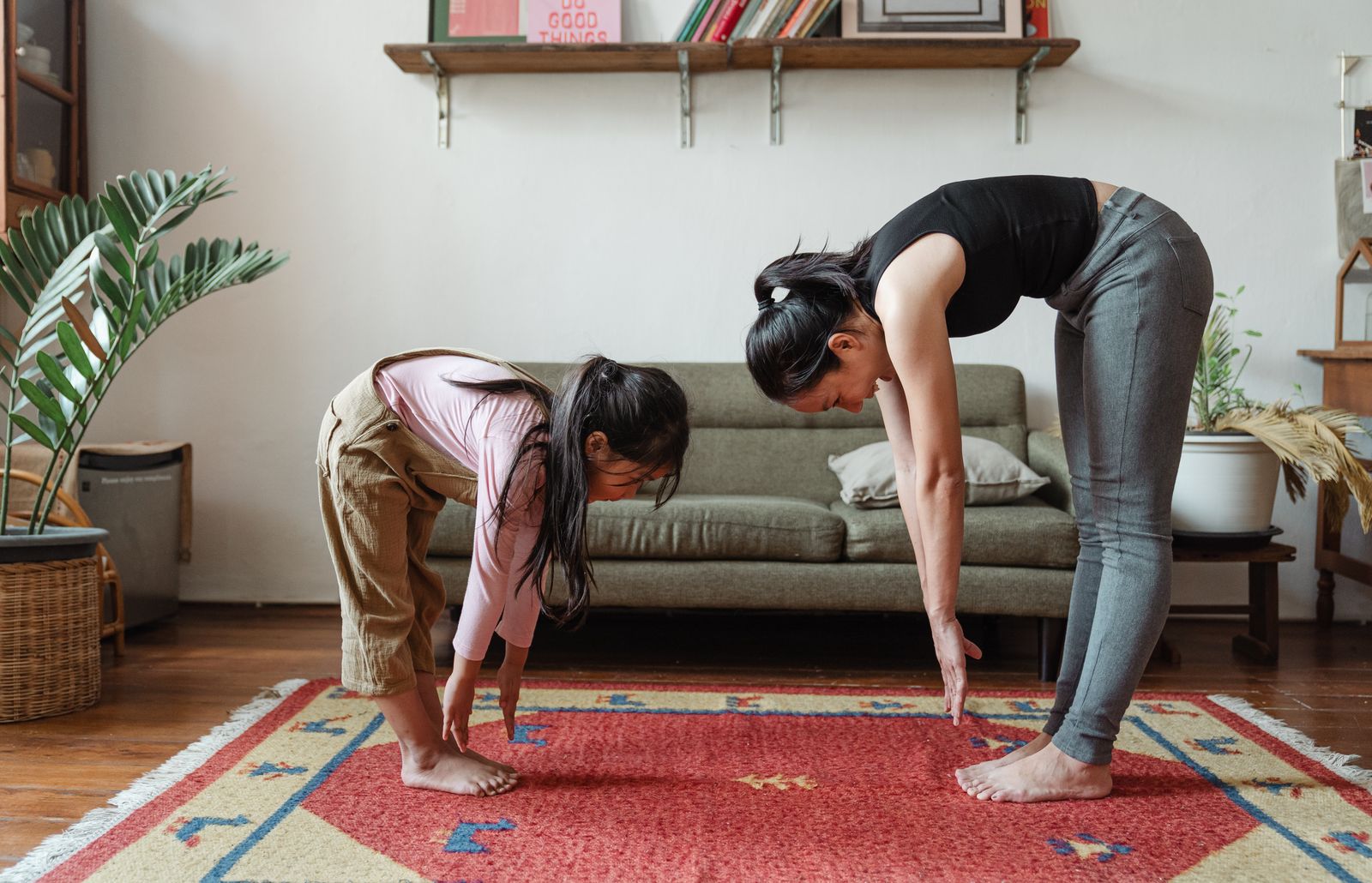 Parent and child doing a guided stretching exercise at home