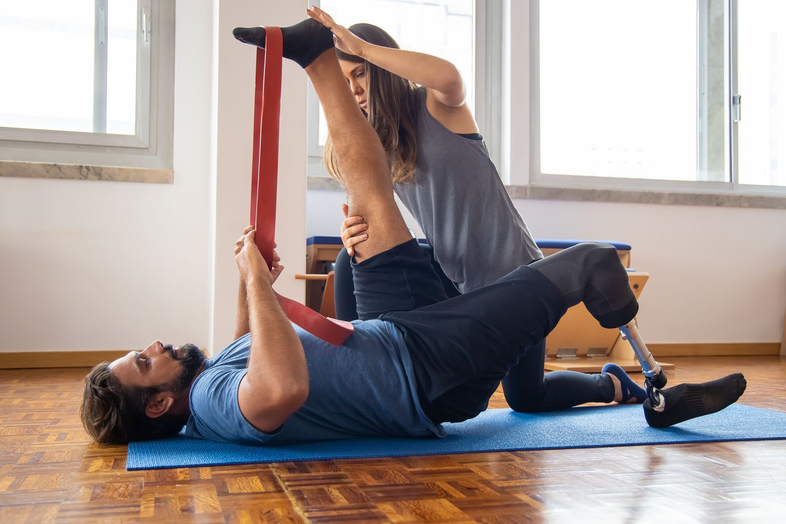 Assisted leg stretch with a resistance band to ease sciatic nerve pain