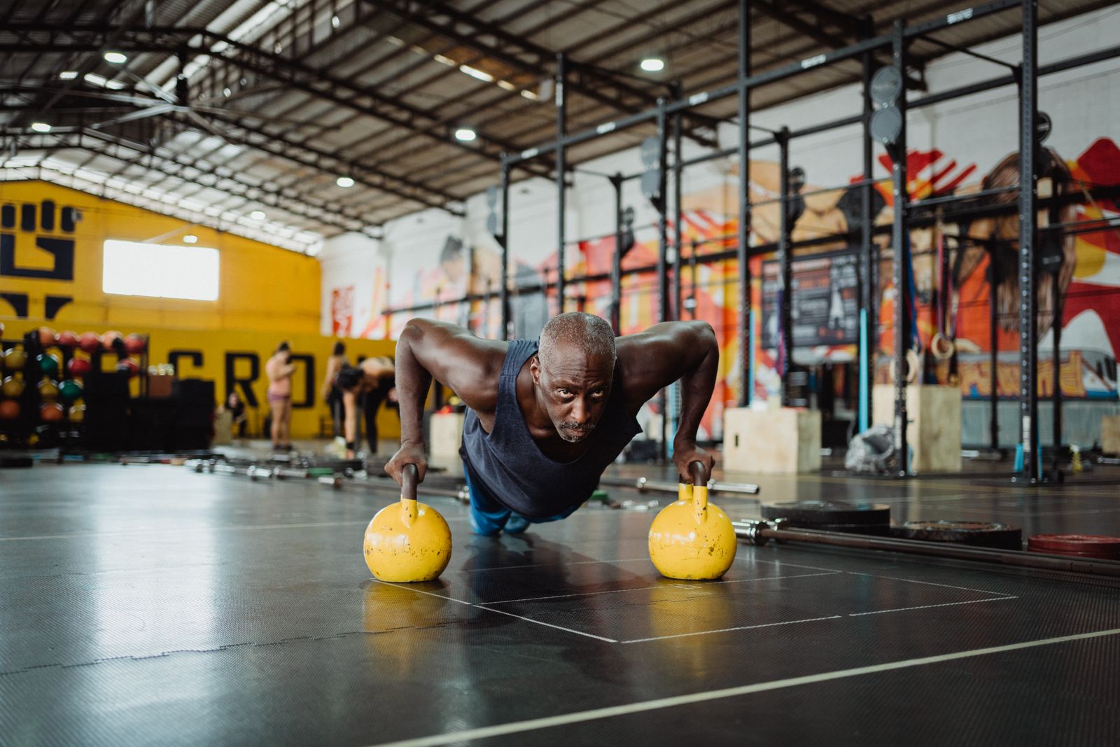 Athlete training with kettlebells in a gym