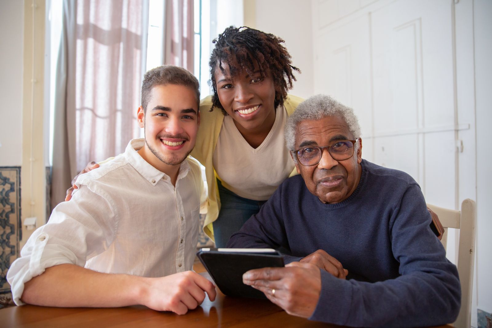 Family members supporting an elderly relative during recovery at home